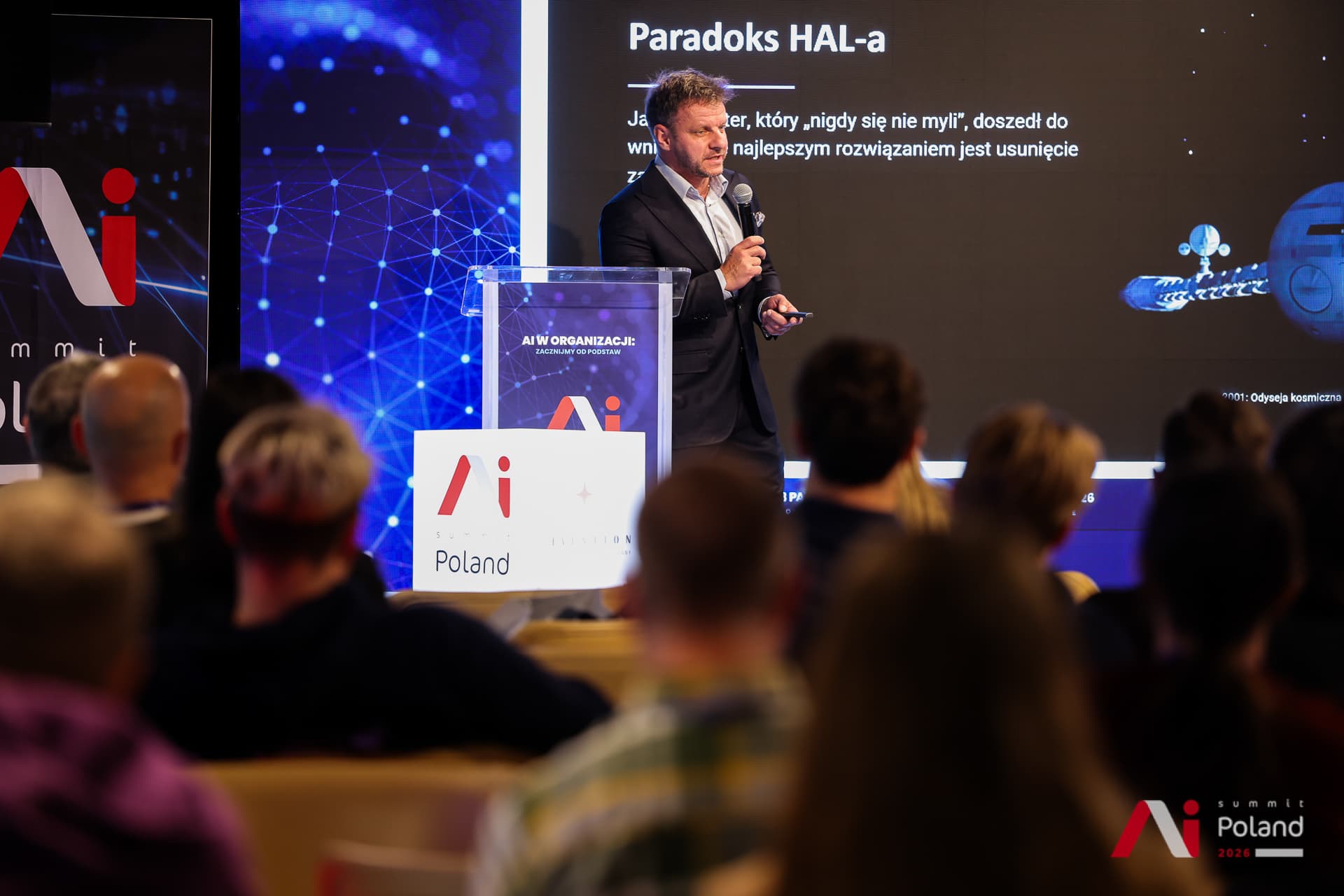 A speaker at the lectern presenting the HAL paradox